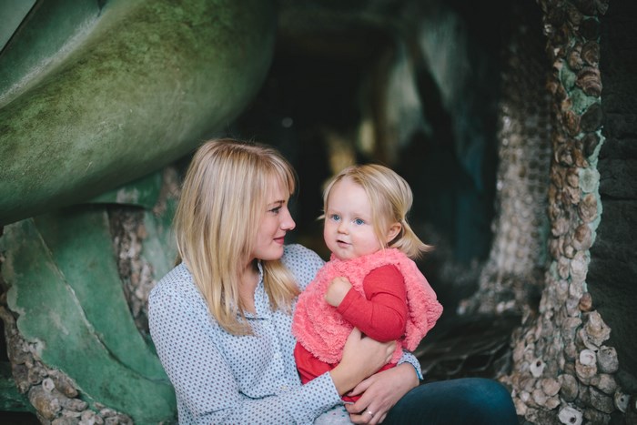 Mother holding her toddler daughter