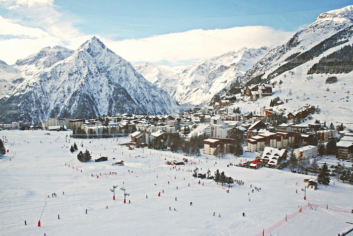 Ski resort village in the French Alps with snow-covered mountains