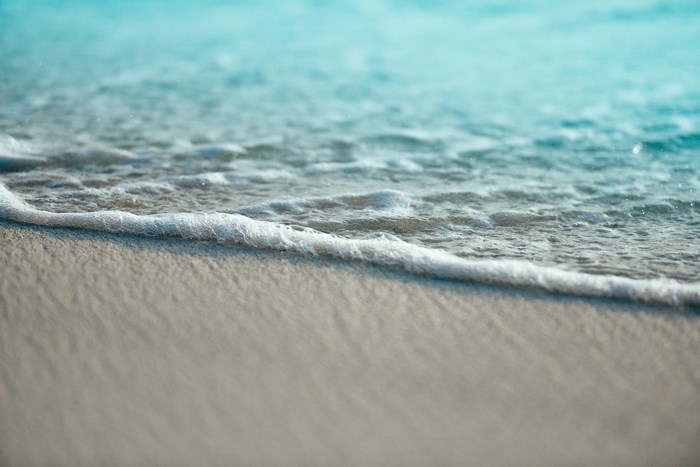 Gentle waves lap onto a sandy beach