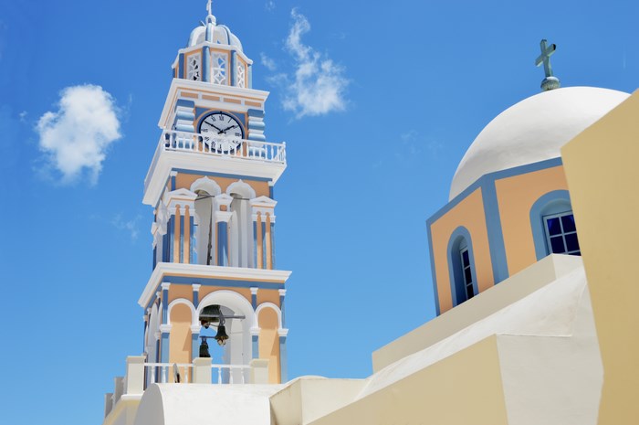 Bell tower and dome of a church against a blue sky