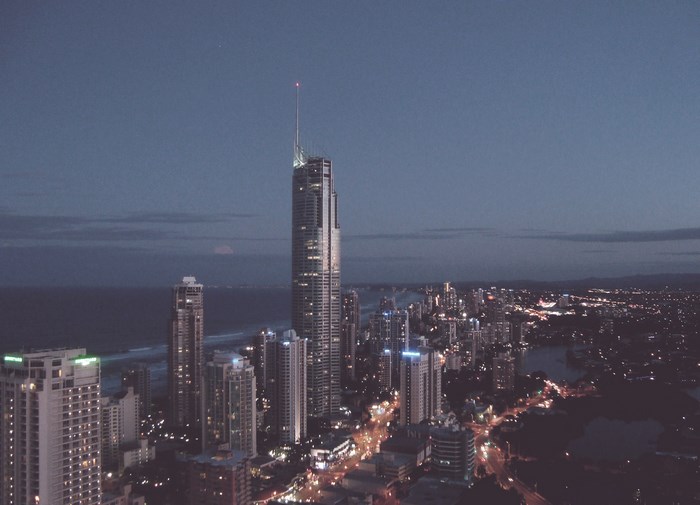Skyscraper city skyline at dusk with ocean view