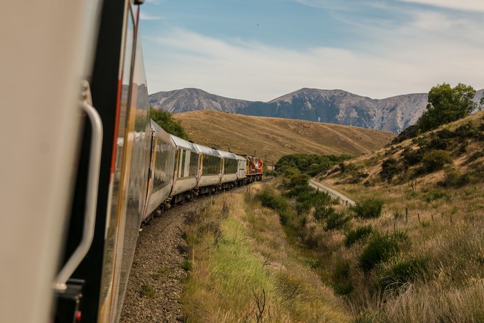 Train traveling through a mountainous landscape