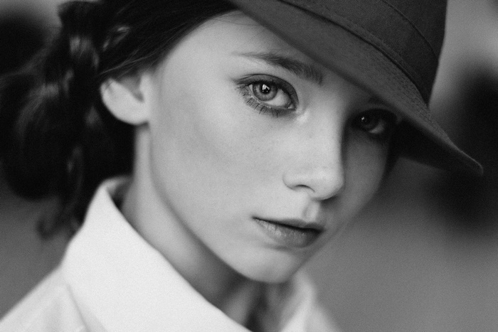 Girl wearing a hat and white shirt, black and white portrait