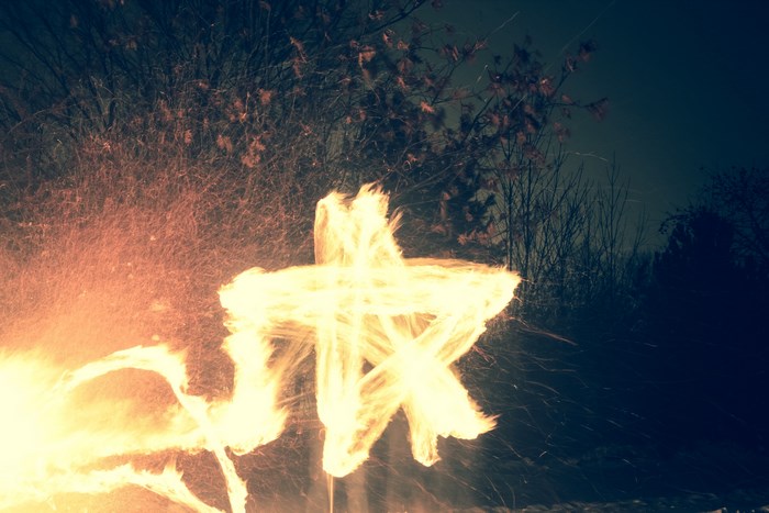 Long exposure of a star made of flame and sparks