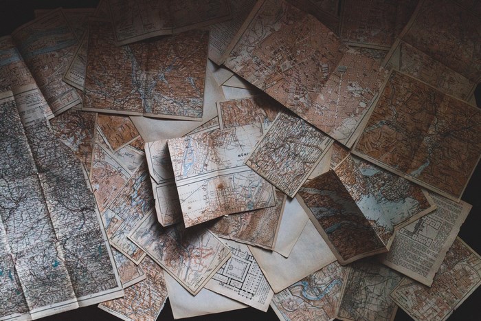 A pile of old, vintage maps spread out