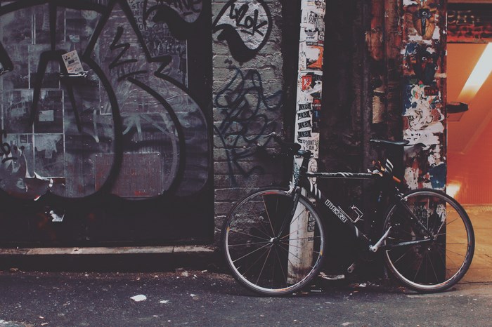 Urban Bicycle Leaning Against Graffiti Wall in Alley Melbourne