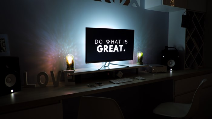 Minimalist Desk Setup with Motivational Apple Screen