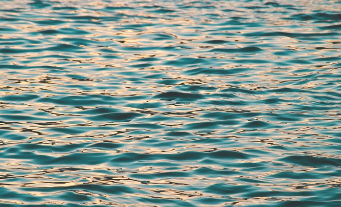 Rippling water reflecting sunset light