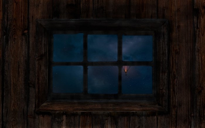 Hot air balloon in the night sky seen through a window