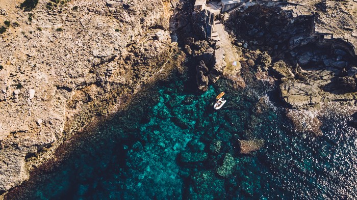 Boat near rocky coast of Mallorca, Spain