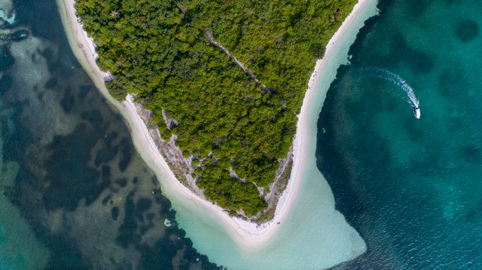 Aerial view of a tropical island with a boat