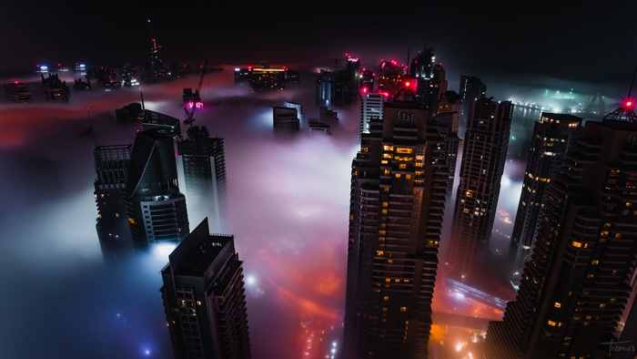 Dubai skyscrapers shrouded in fog at night