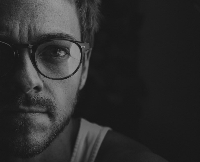 Black and white portrait of a man with glasses