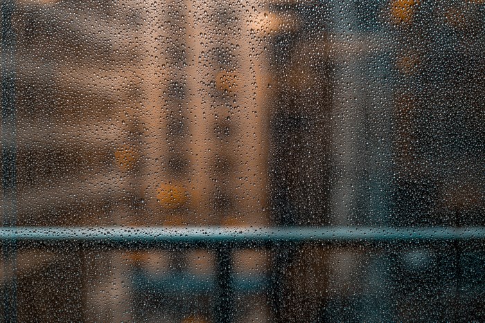 Rainy City View Through Droplet Covered Window