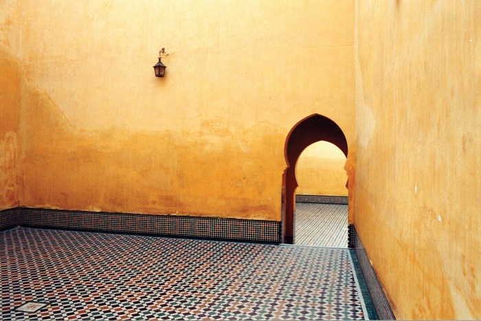 Moroccan interior with yellow walls and mosaic tiles