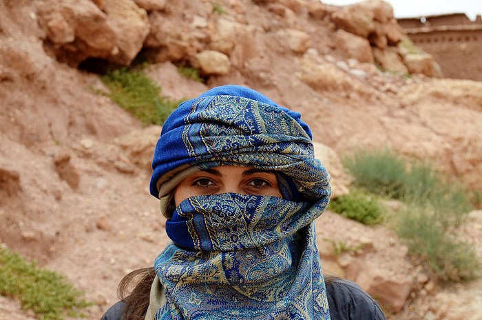 Woman wearing a blue headscarf in Merzouga desert