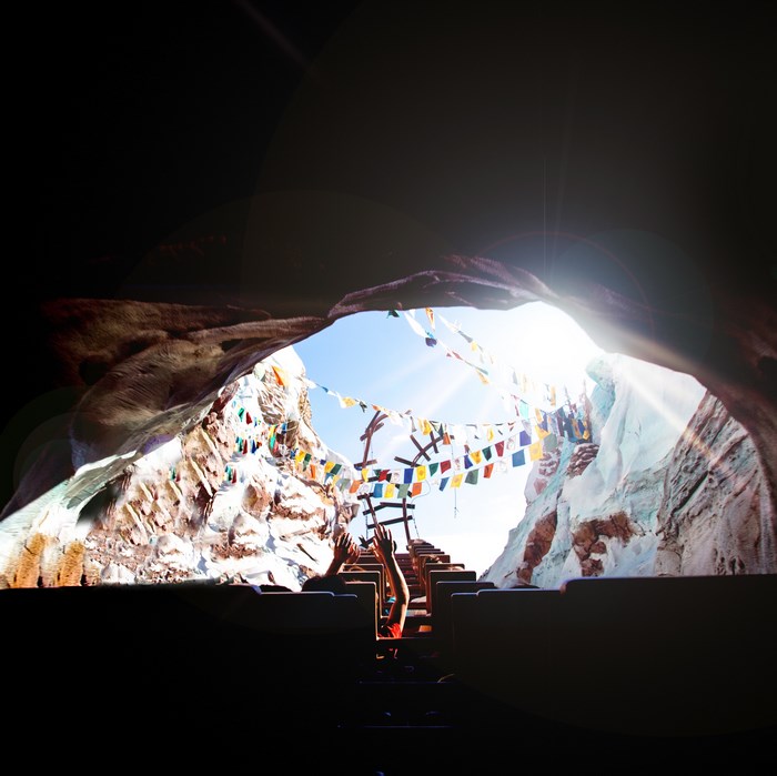 Roller coaster ride through a cave with prayer flags