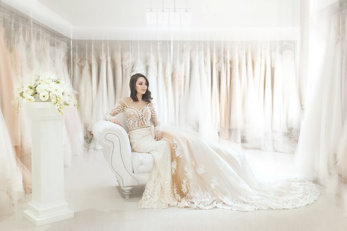 Bride in Elegant Lace Wedding Dress Sitting on Sofa