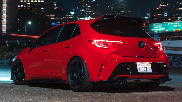 Red Toyota Corolla Hatchback with custom tuning at night
