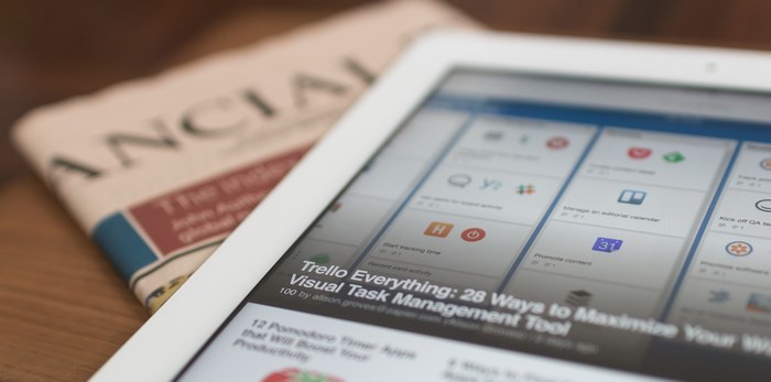 Tablet displaying Trello with Financial Times newspaper