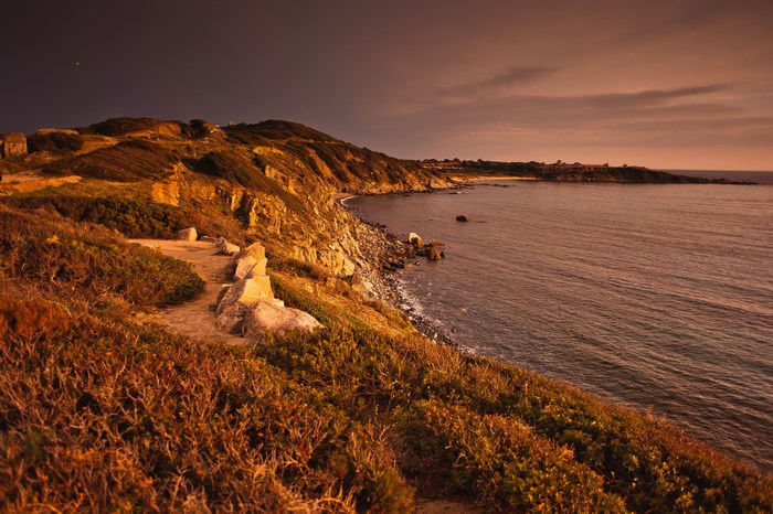 Coastal cliff overlooking the sea at dusk