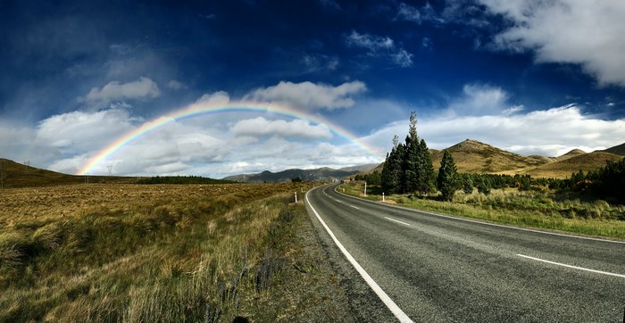 Rainbow over a road in South Island, New Zealand