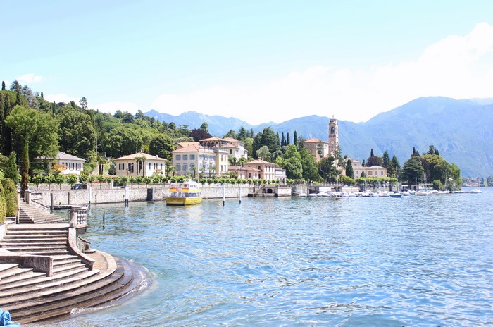 Lake Como village with mountains and a yellow boat