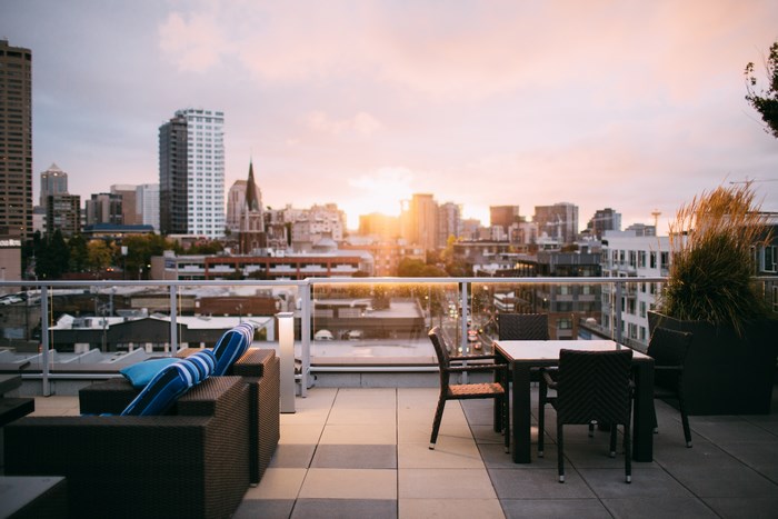 Rooftop lounge with Seattle skyline at sunset