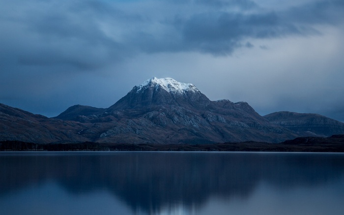Snow-capped mountain reflected in a calm lake