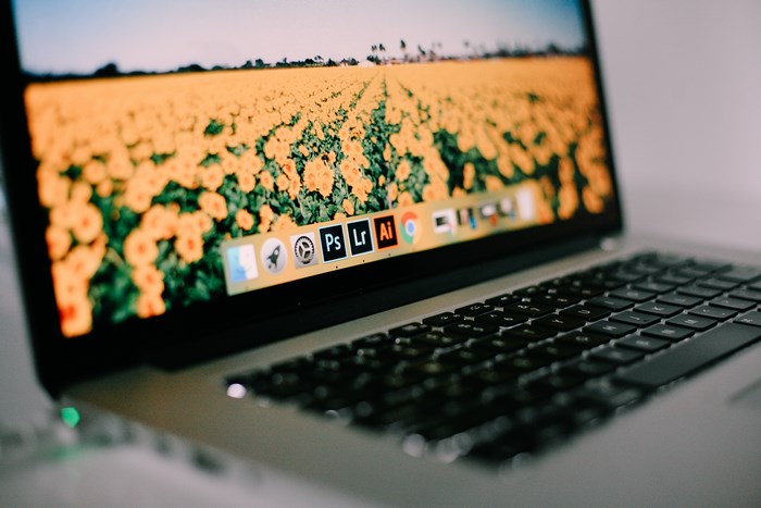 Apple MacBook with flower field wallpaper