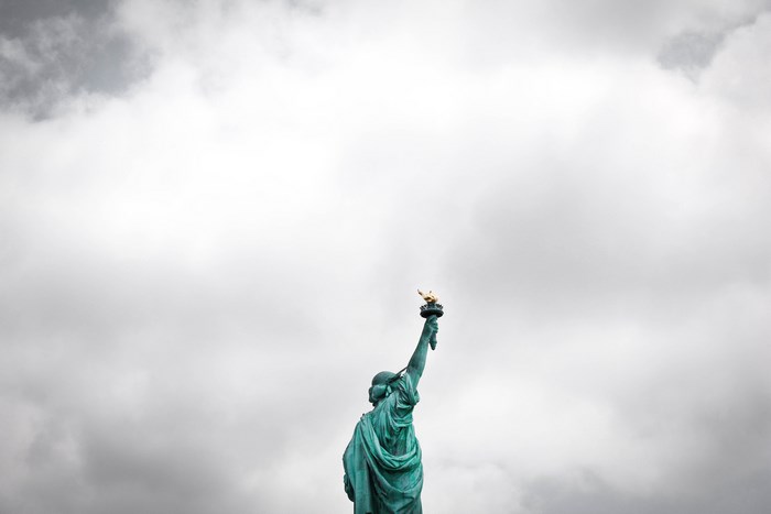 Statue of Liberty against a cloudy sky