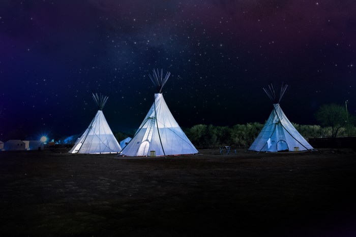 Night Sky Over Native American Teepees in Desert