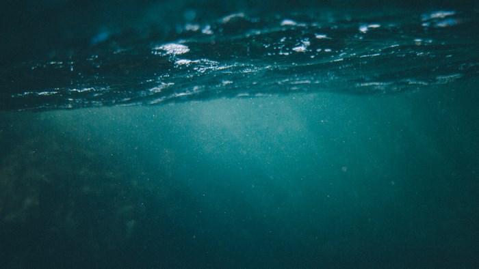 Underwater view of the ocean surface with light rays