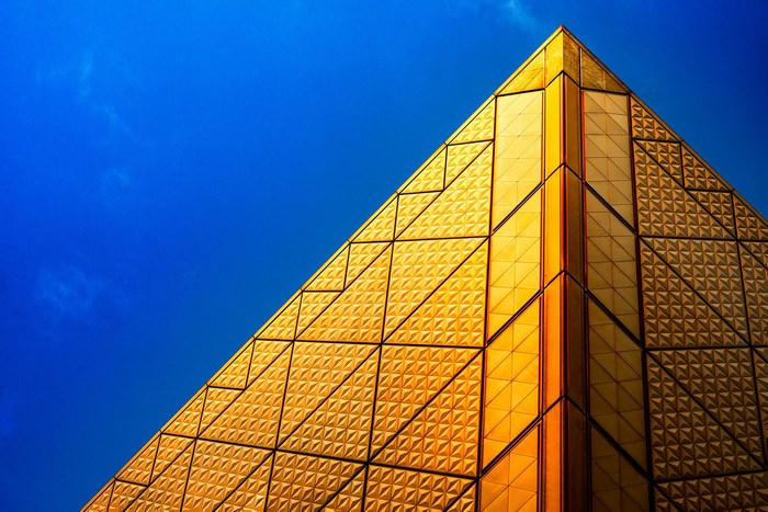 Golden Pyramid Facade Against Blue Sky in Tokyo