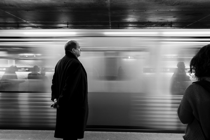 Man and woman waiting for a train in a subway station