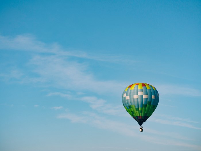 Hot air balloon floating in a blue sky