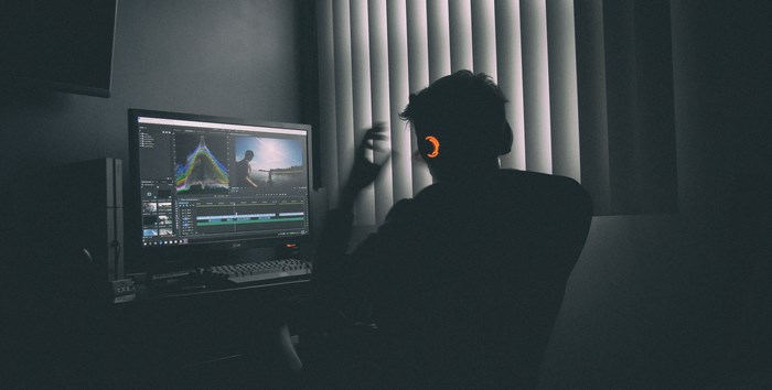 Person editing video on Premiere Pro on a computer