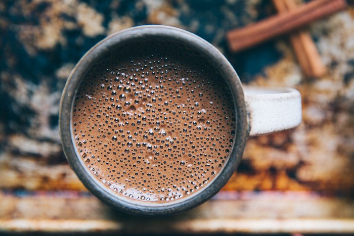 Cup of hot chocolate with cinnamon sticks