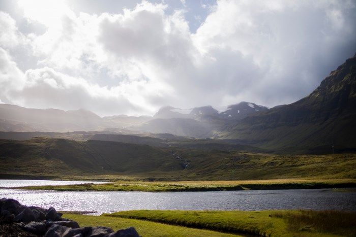 Sunlight over a mountain valley with a lake
