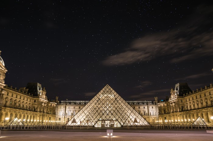 The Louvre Pyramid at Night Under Starry Sky