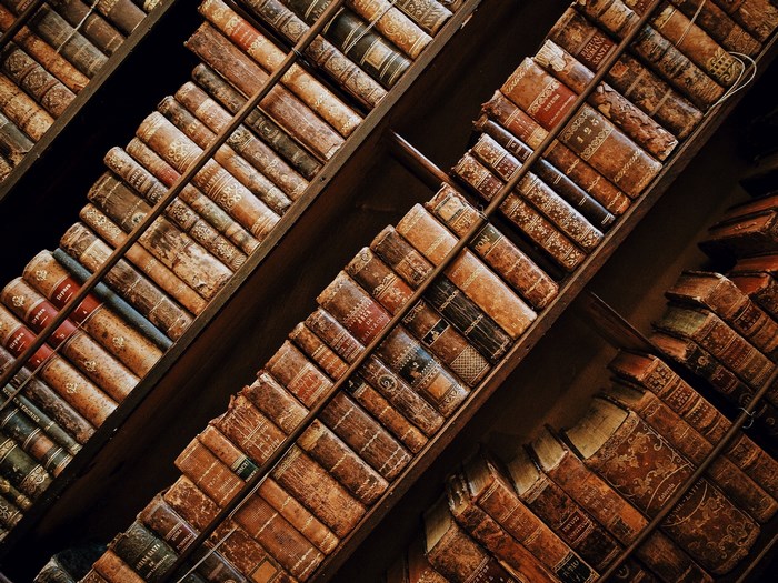 Antique books on a wooden bookshelf