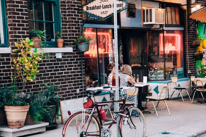 Restaurant with neon sign and bicycle