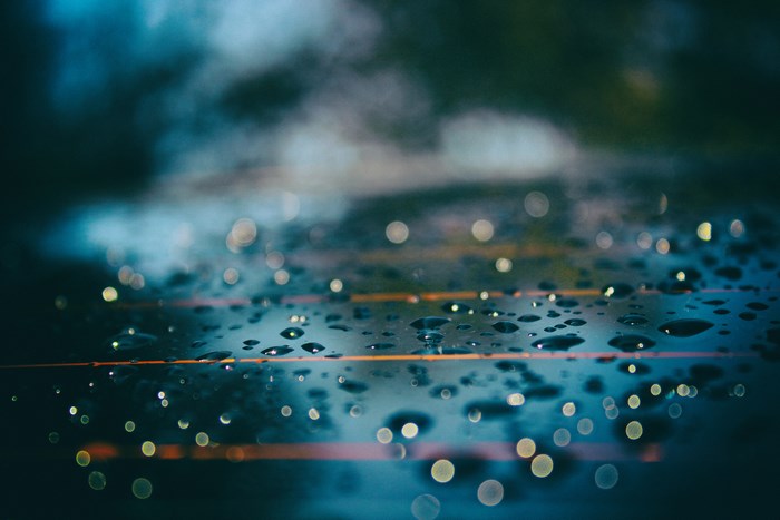 Water drops and bokeh on a dark surface