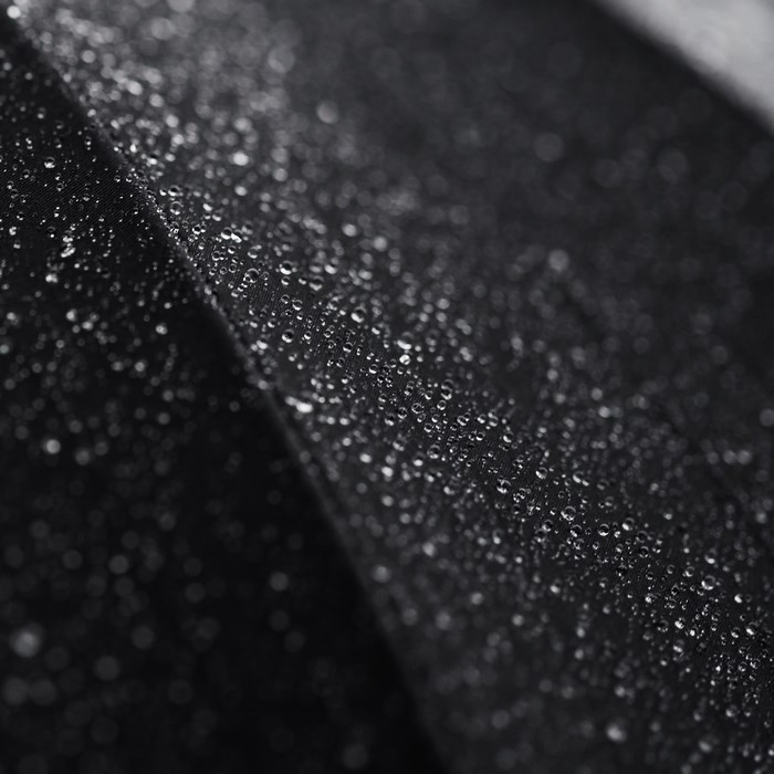 Close-up of water drops on black fabric