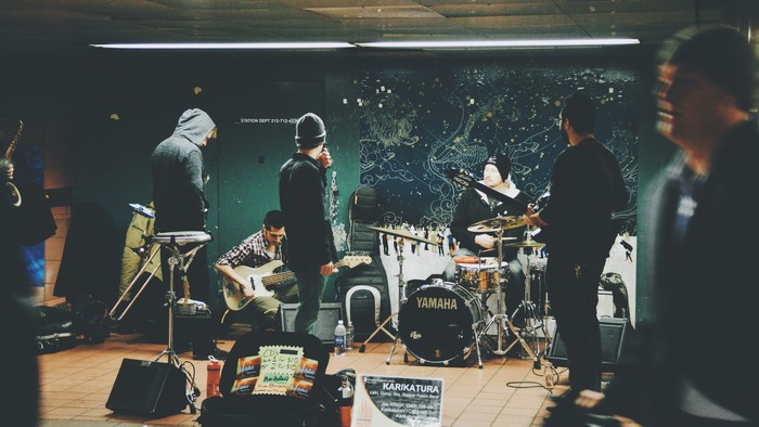 Indie band performing music in a subway station