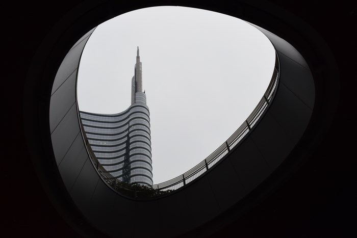 Curved architecture framing a modern skyscraper