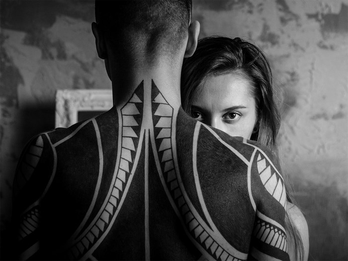 Man with blackwork tattoo and woman