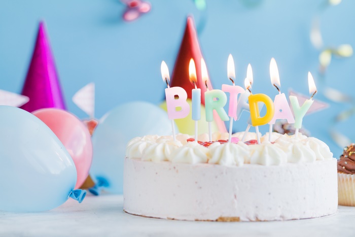 Birthday cake with candles and balloons