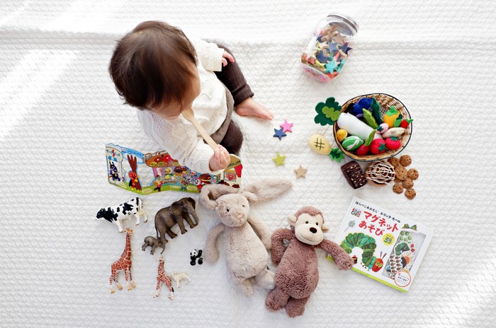 Baby playing with toys and books