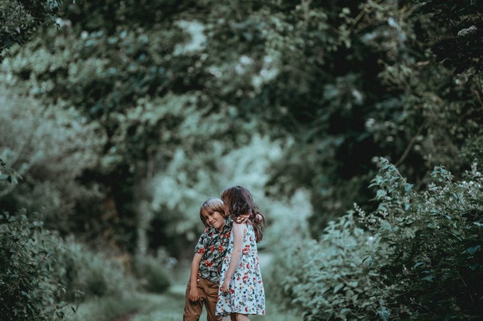 Boy and girl hugging in a forest